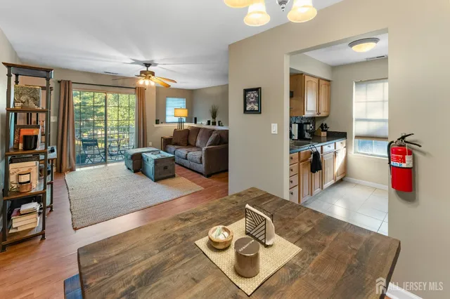 a living room with furniture hard wood floor and a flat screen tv