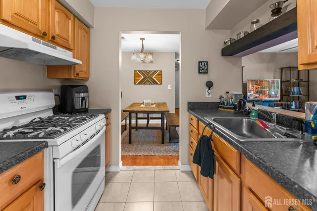 a kitchen with stainless steel appliances granite countertop a stove and a sink