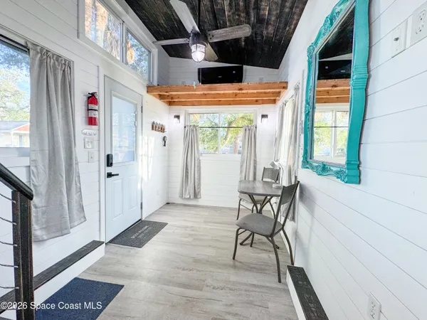 a view of an entryway with wooden floor and windows