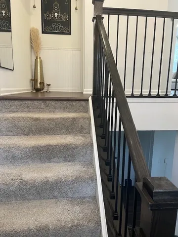a view of staircase with wooden floor and stairs