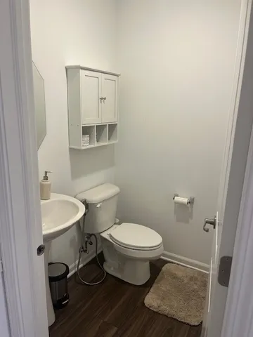 a bathroom with a sink toilet a mirror and vanity