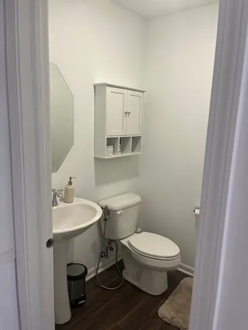 a white toilet sitting next to a bathroom sink