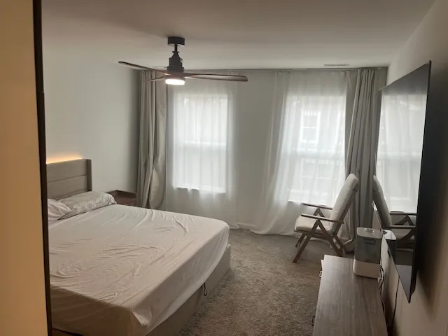 a spacious bedroom with a bed and a window