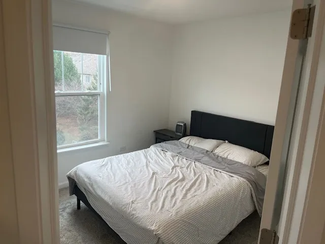 a bedroom with a bed and window