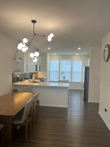 a kitchen with a table and chairs in it