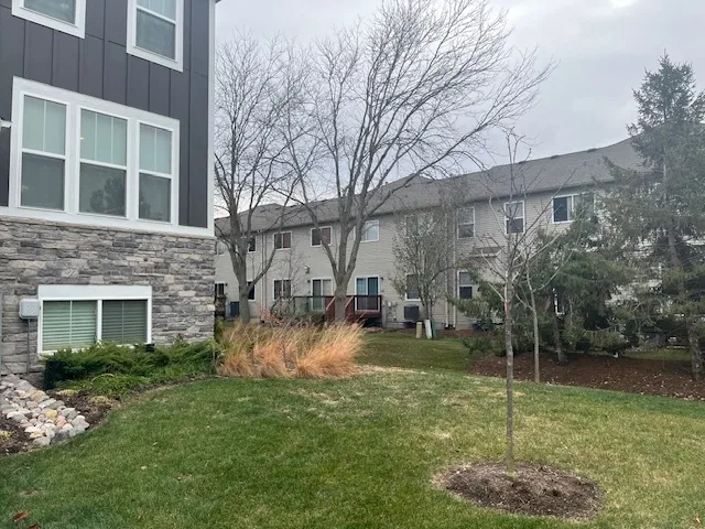 a backyard of a house with plants and outdoor seating
