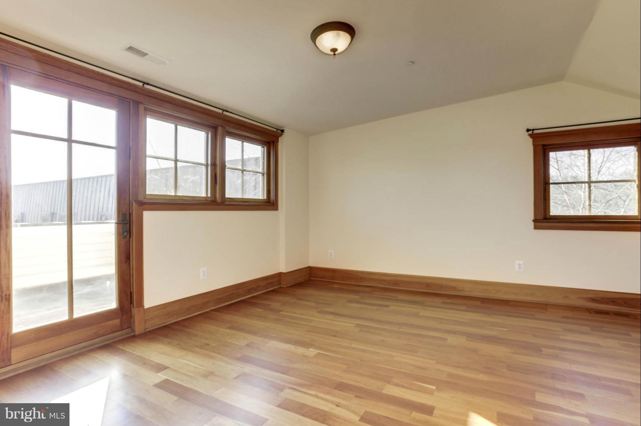 24 Dean Street Annapolis, MD 21401 - Photo 22 of 30 an empty room with wooden floor and windows