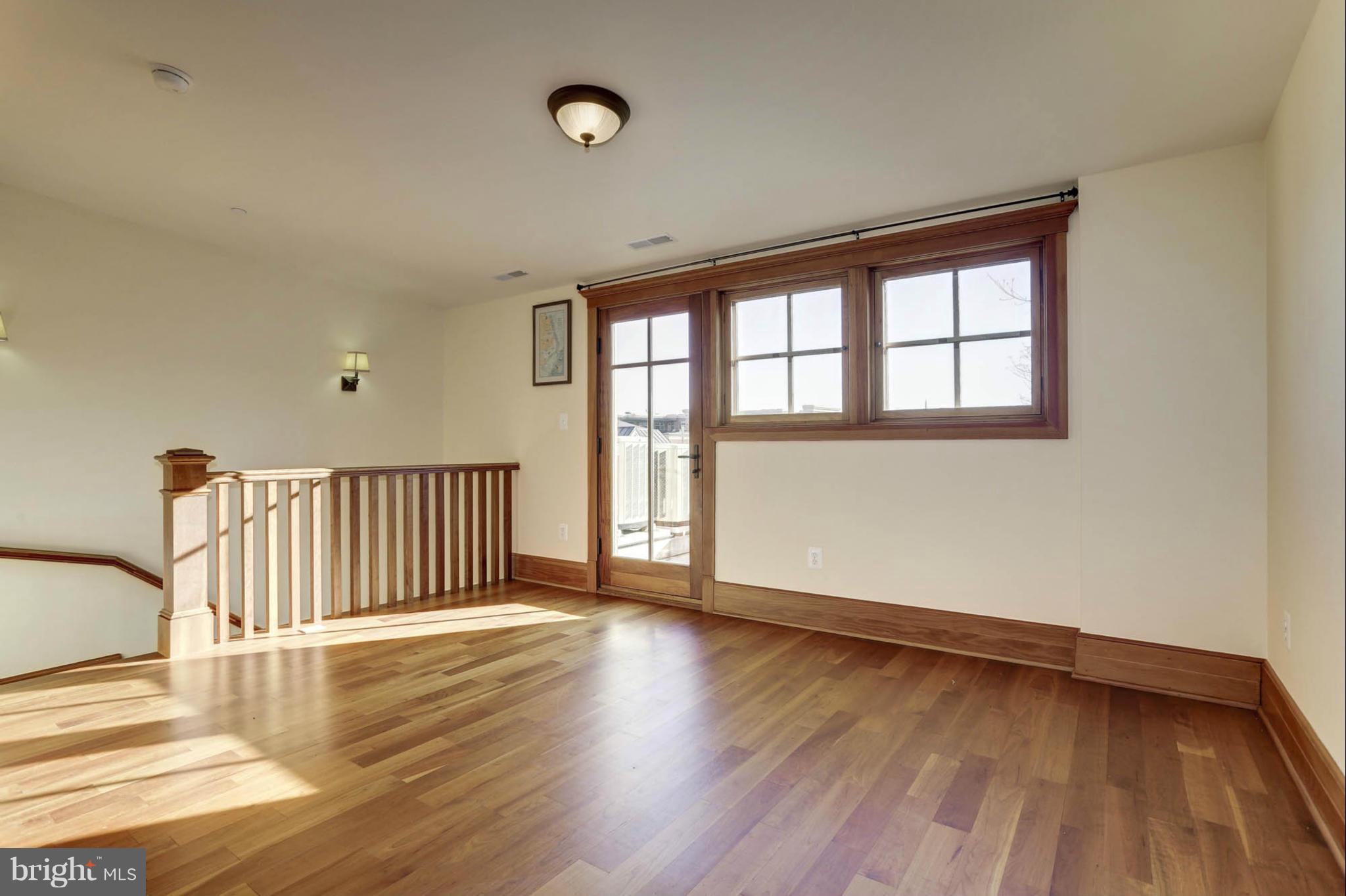 24 Dean Street Annapolis, MD 21401 - Photo 23 of 30 a view of an empty room with wooden floor and a window