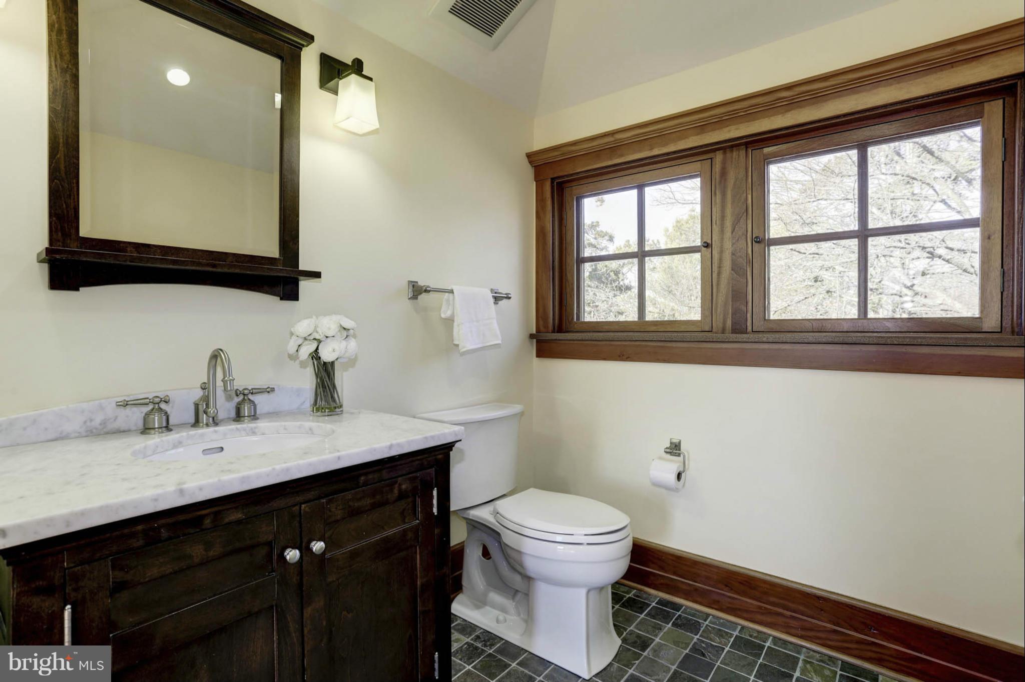 24 Dean Street Annapolis, MD 21401 - Photo 24 of 30 a bathroom with a toilet sink and mirror