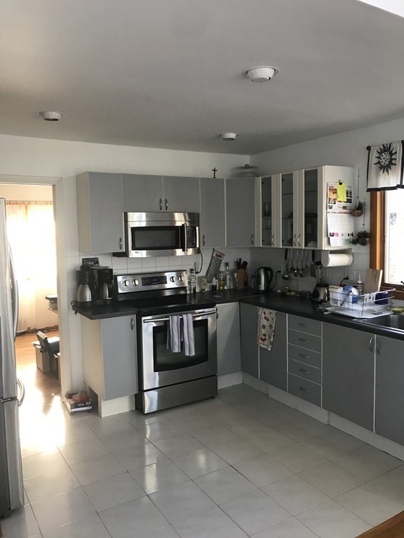 139 Congamond Road Southwick, MA 01077 - Photo 2 of 10 a kitchen with stainless steel appliances a stove a sink and a microwave
