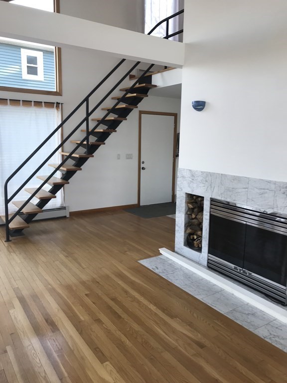 139 Congamond Road Southwick, MA 01077 - Photo 3 of 10 a view of an empty room with wooden floor and a fireplace