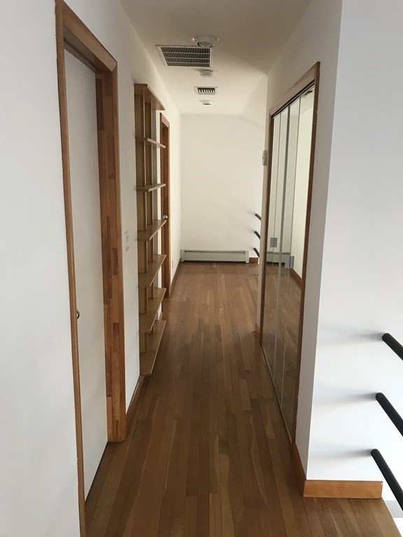 139 Congamond Road Southwick, MA 01077 - Photo 7 of 10 a view of a hallway with wooden floor and staircase
