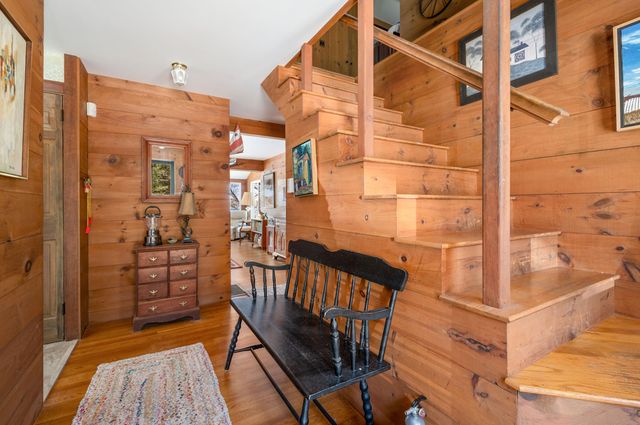 a living room with furniture a fireplace and a floor to ceiling window