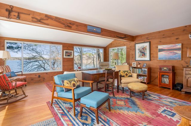 a bedroom with a bed and a dresser next to a window
