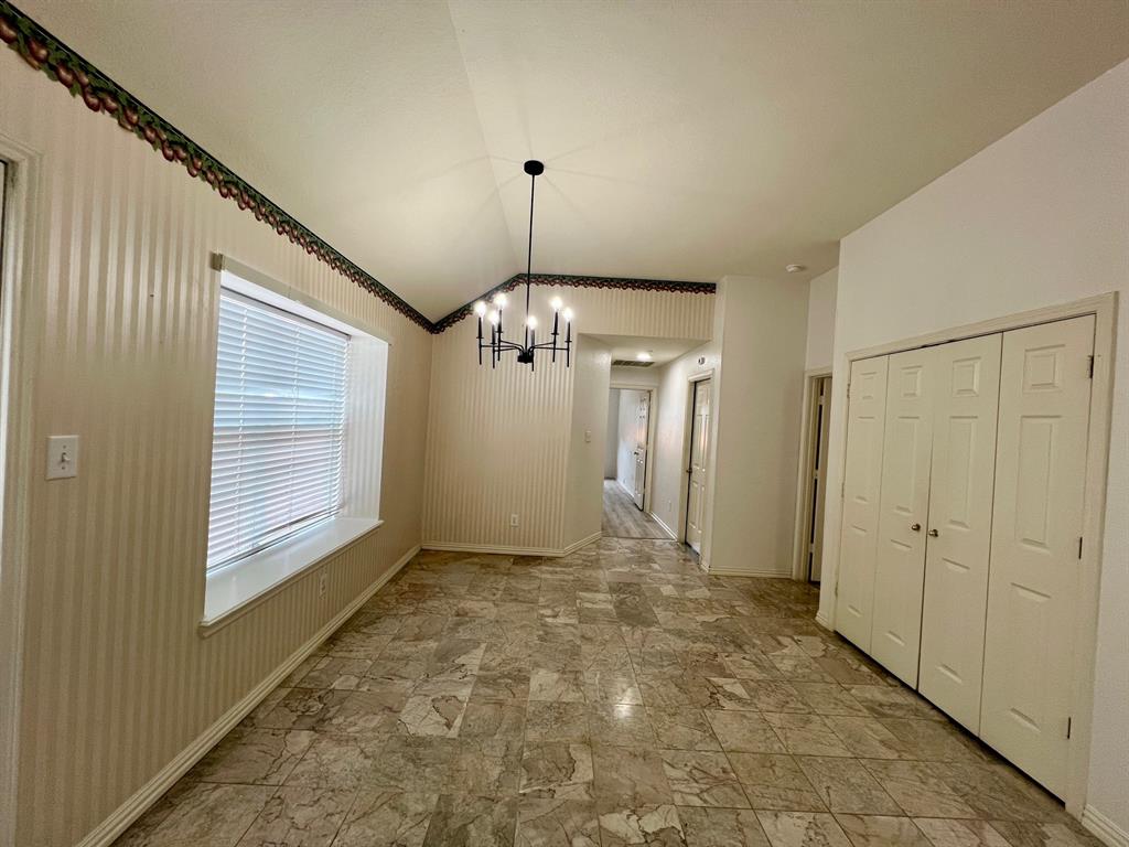 1348 Riley Drive Carrollton, TX 75007 - Photo 6 of 11 a view of a hallway with a chandelier