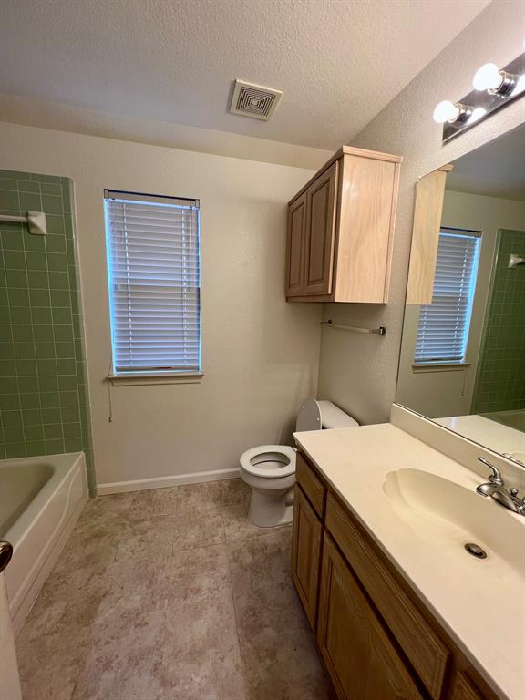 1348 Riley Drive Carrollton, TX 75007 - Photo 9 of 11 a bathroom with a sink toilet and mirror