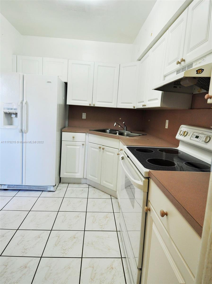 7420 Southwest 6th Street Miami, FL 33144 - Photo 13 of 21 a kitchen with a sink and cabinets