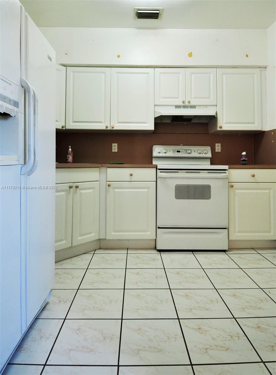 7420 Southwest 6th Street Miami, FL 33144 - Photo 14 of 21 a kitchen with cabinets and appliances