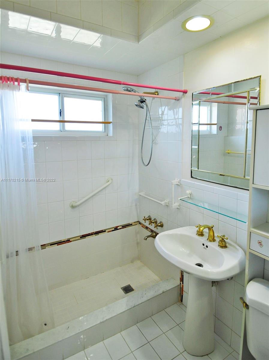 7420 Southwest 6th Street Miami, FL 33144 - Photo 18 of 21 a bathroom with a sink a mirror and a shower