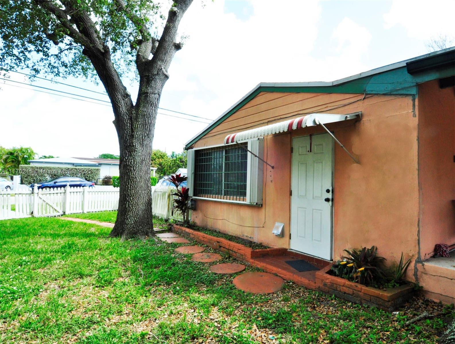 7420 Southwest 6th Street Miami, FL 33144 - Photo 19 of 21 a backyard of a house with table and chairs