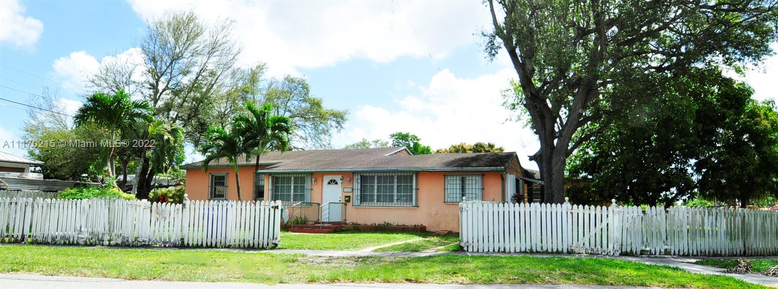 7420 Southwest 6th Street Miami, FL 33144 - Photo 4 of 21 a front view of a house with a yard and a large tree