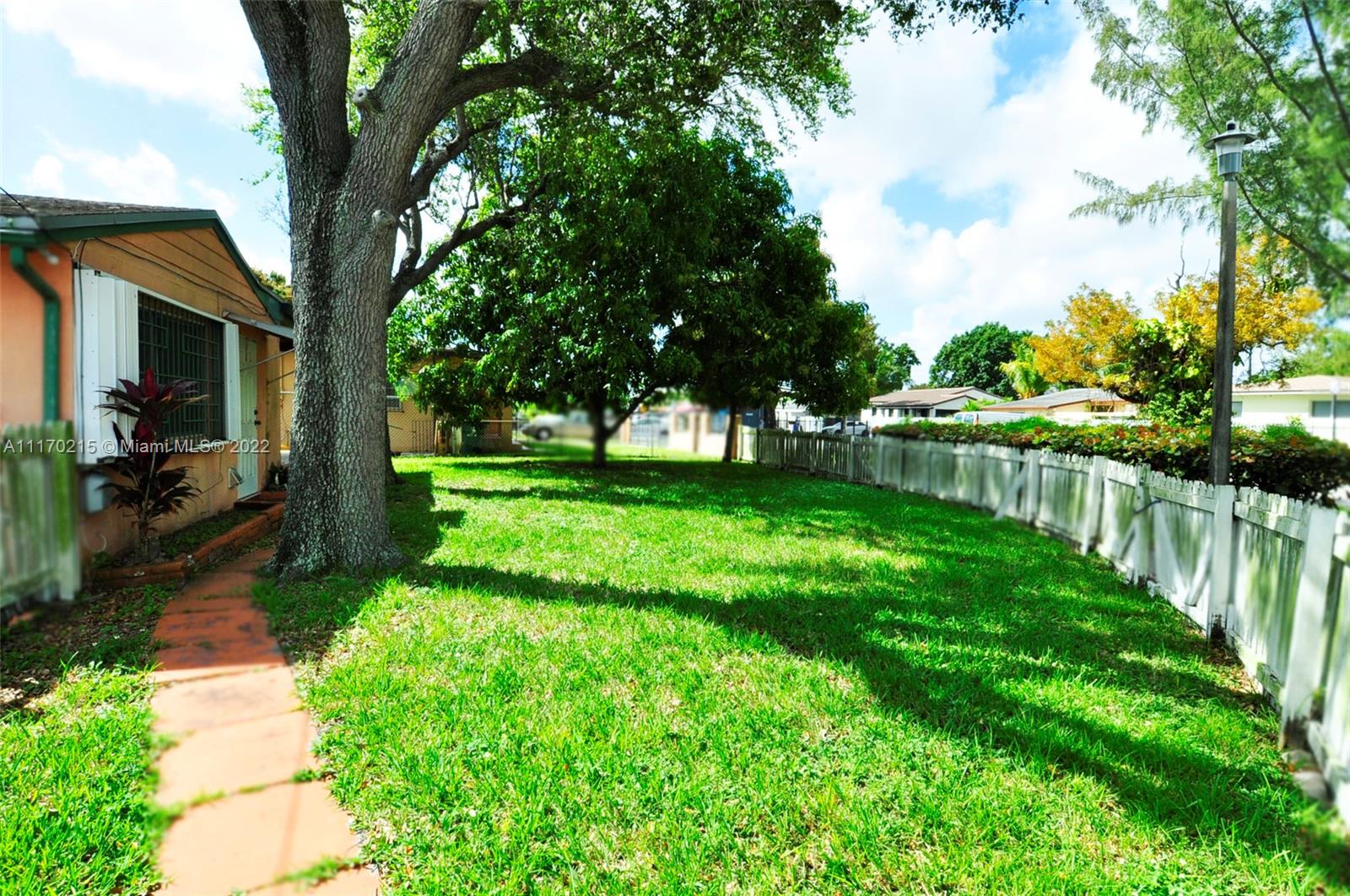 7420 Southwest 6th Street Miami, FL 33144 - Photo 6 of 21 a view of backyard with table and chairs and a large tree