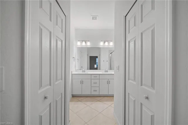 a bathroom with a double vanity sink and a mirror