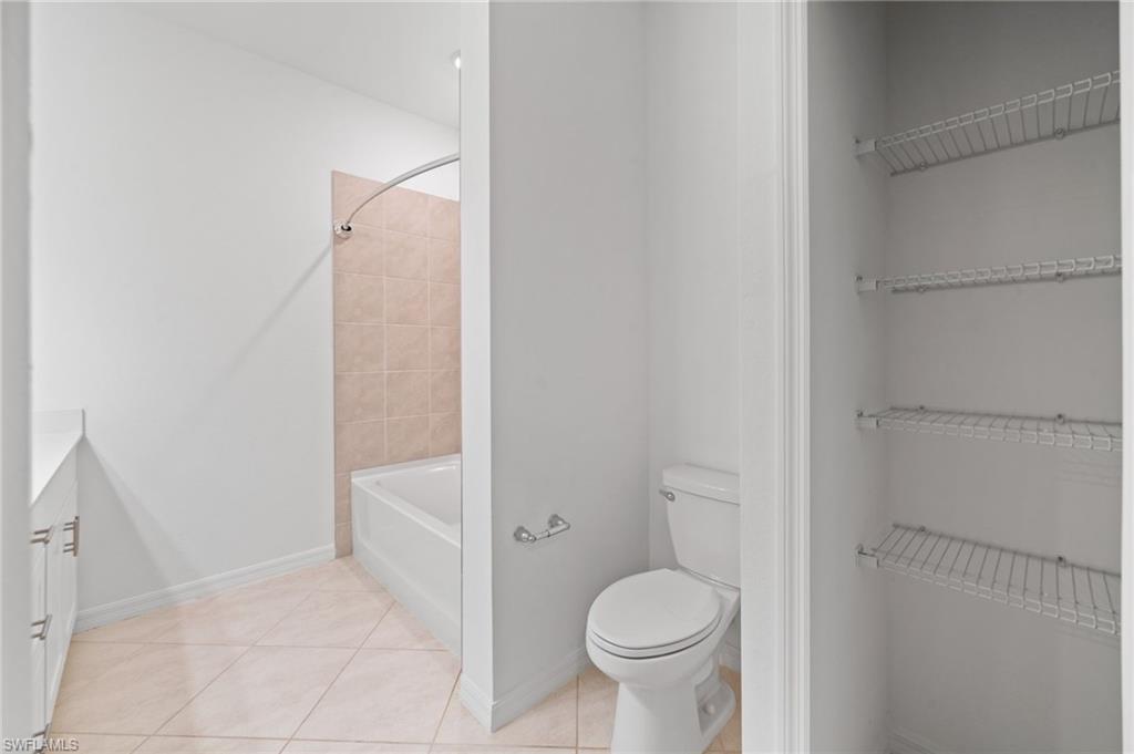 2878 Blossom Way Naples, FL 34120 - Photo 26 of 40 a bathroom with a granite countertop sink toilet and shower