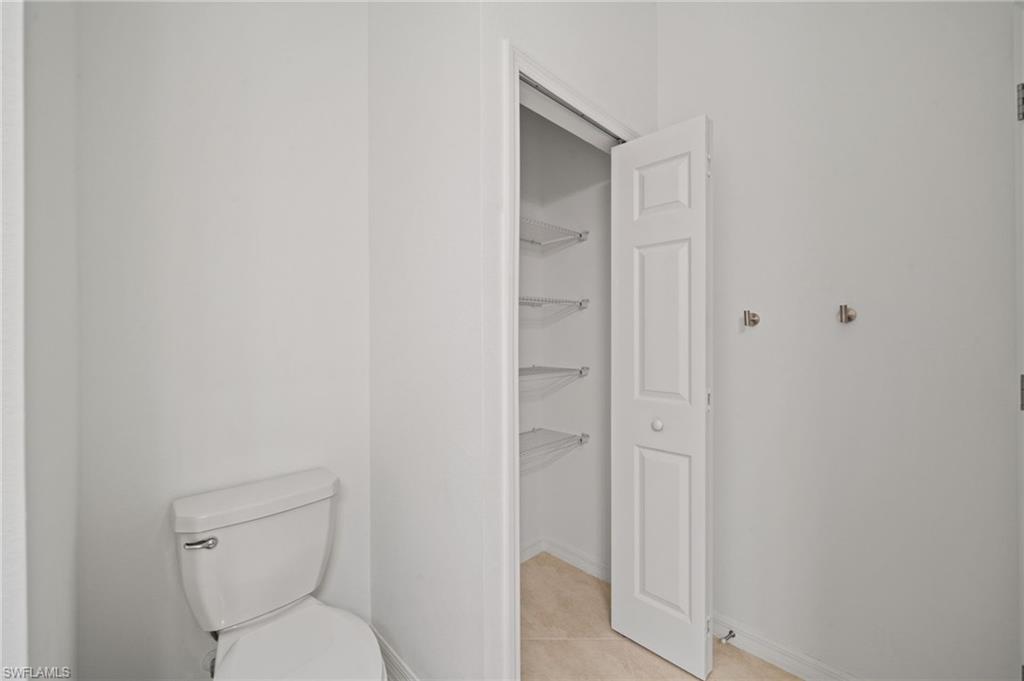 2878 Blossom Way Naples, FL 34120 - Photo 29 of 40 a bathroom with a toilet and a shower