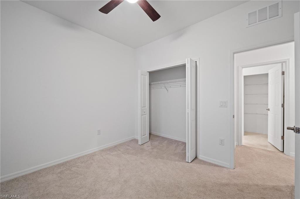 2878 Blossom Way Naples, FL 34120 - Photo 32 of 40 an empty room with chandelier fan