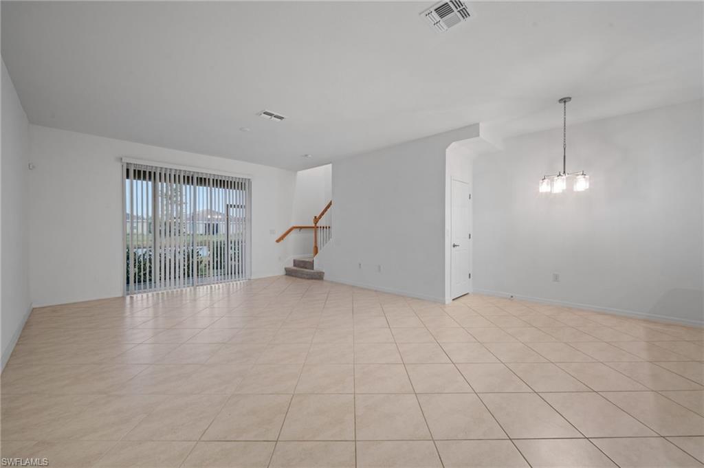 2878 Blossom Way Naples, FL 34120 - Photo 8 of 40 an empty room with fireplace and windows