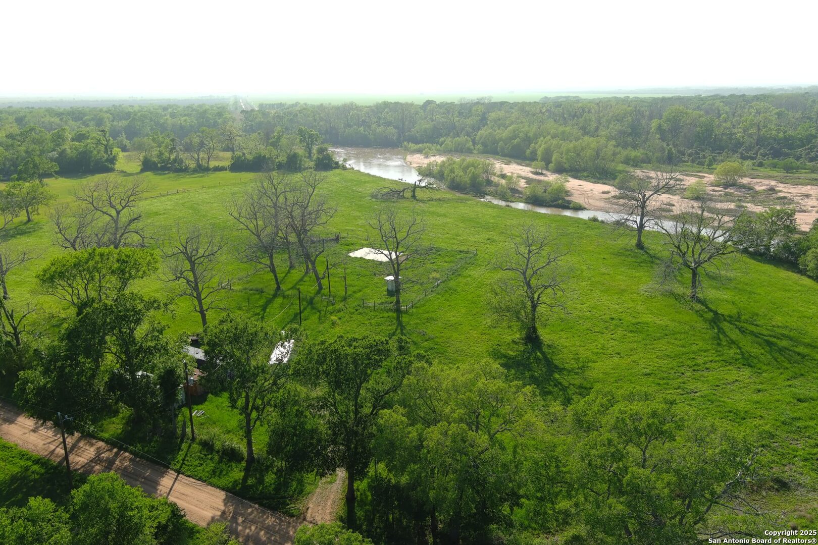 3780 County Road 257 Eagle Lake, TX 77434 - Photo 32 of 35 a view of a lush green outdoor space with a lake view