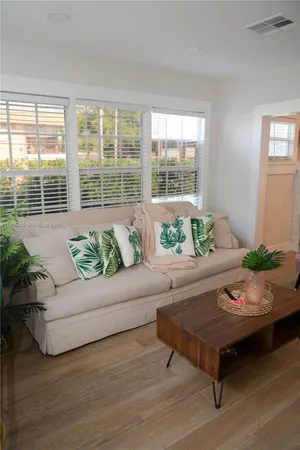 a living room with furniture and a potted plant