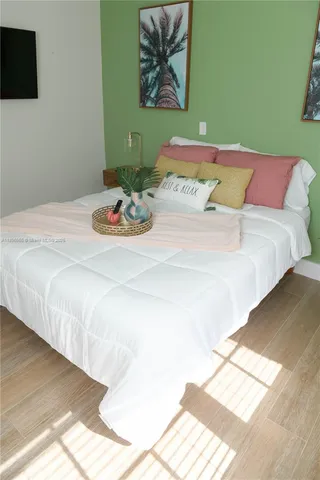 a bedroom with a bed and a flat screen tv