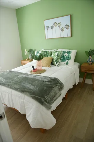 a bed sitting in a bedroom next to a wall