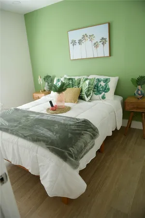 a bed sitting in a bedroom next to a wall