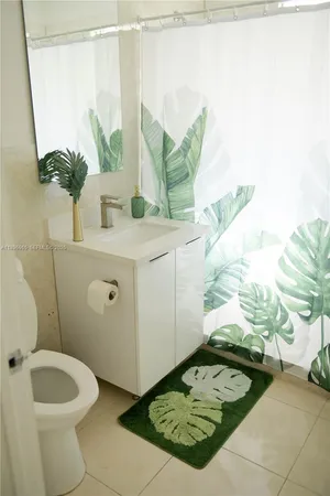 a bathroom with a sink toilet and mirror
