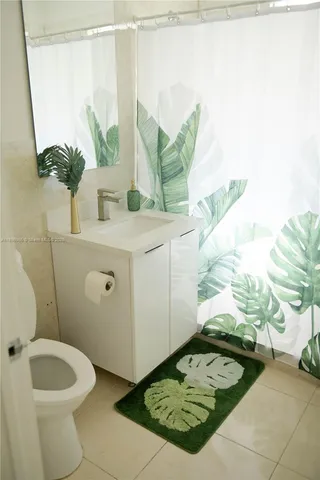 a bathroom with a sink toilet and mirror