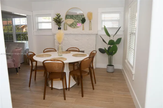 a view of a dining room with furniture and a potted plant