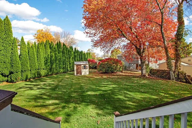 a backyard of a house with table and chairs