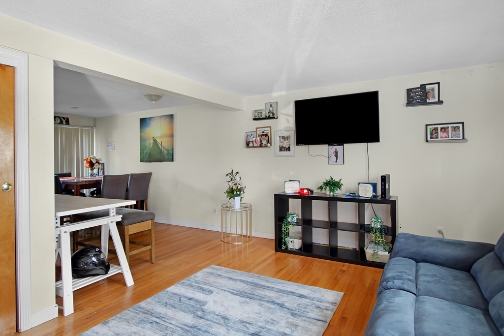 26 Moreland Avenue, Unit 28 Dedham, MA 02026 - Photo 4 of 18 a living room with furniture and a flat screen tv