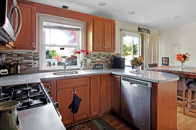 a kitchen with stainless steel appliances a sink stove and cabinets