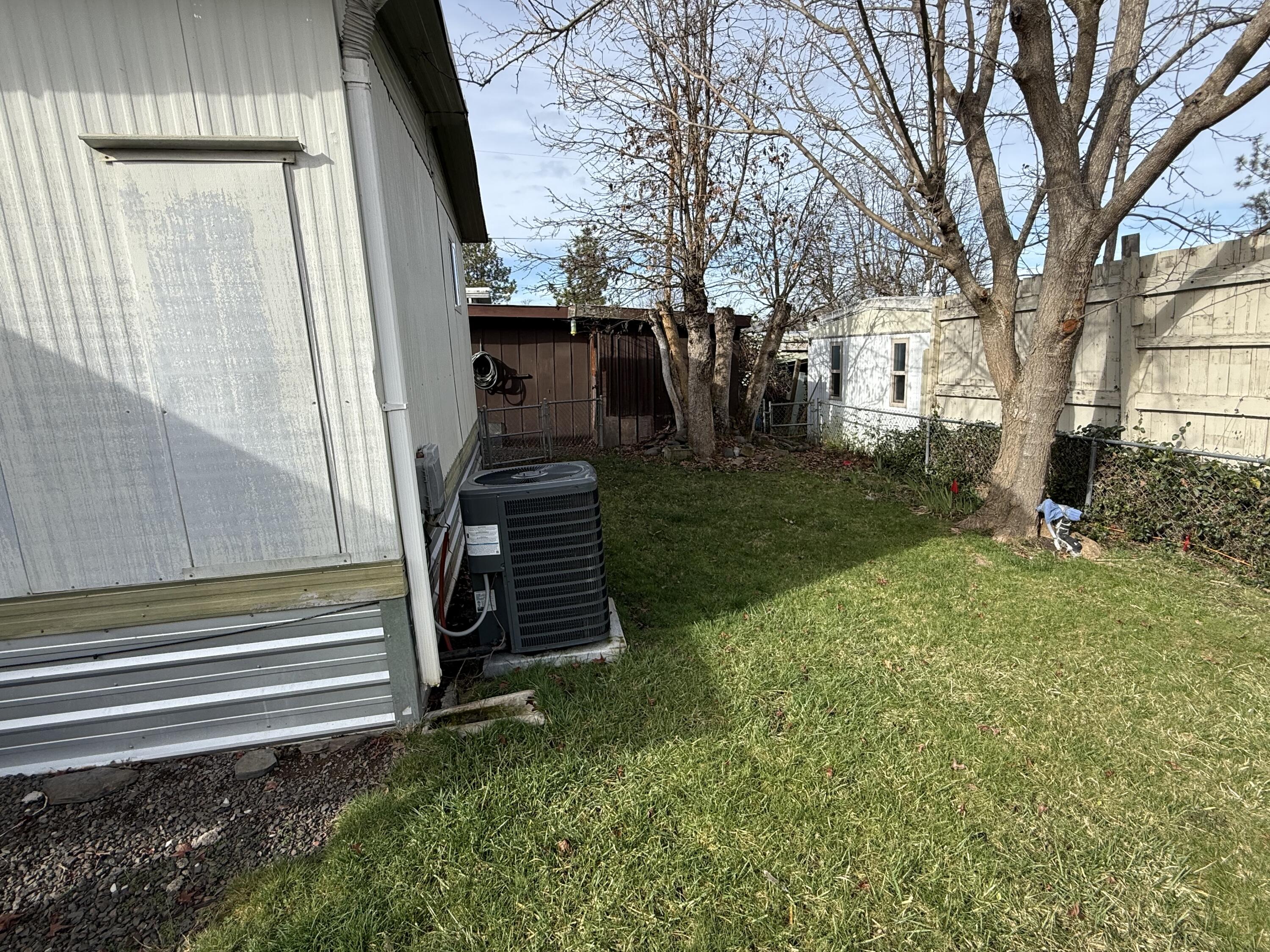 421 Stevens Road, Unit 20 Eagle Point, OR 97524 - Photo 20 of 22 a view of backyard with wooden fence and a large tree