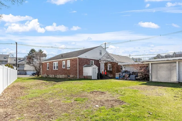 a view of a house with a big yard and large trees