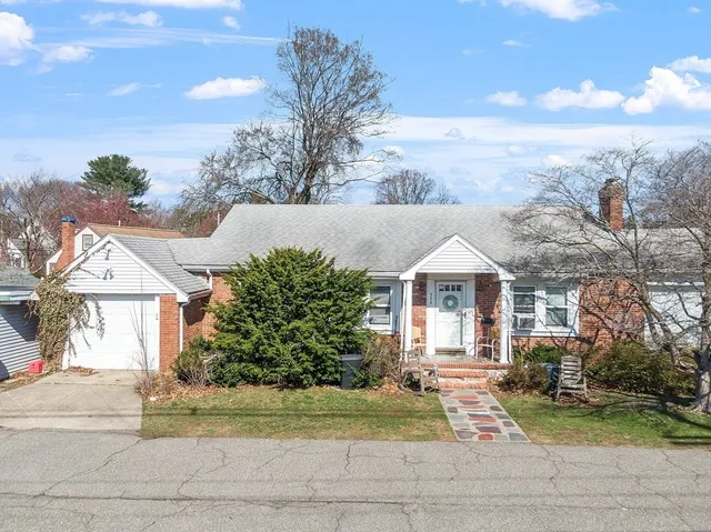 a front view of a house with a garden