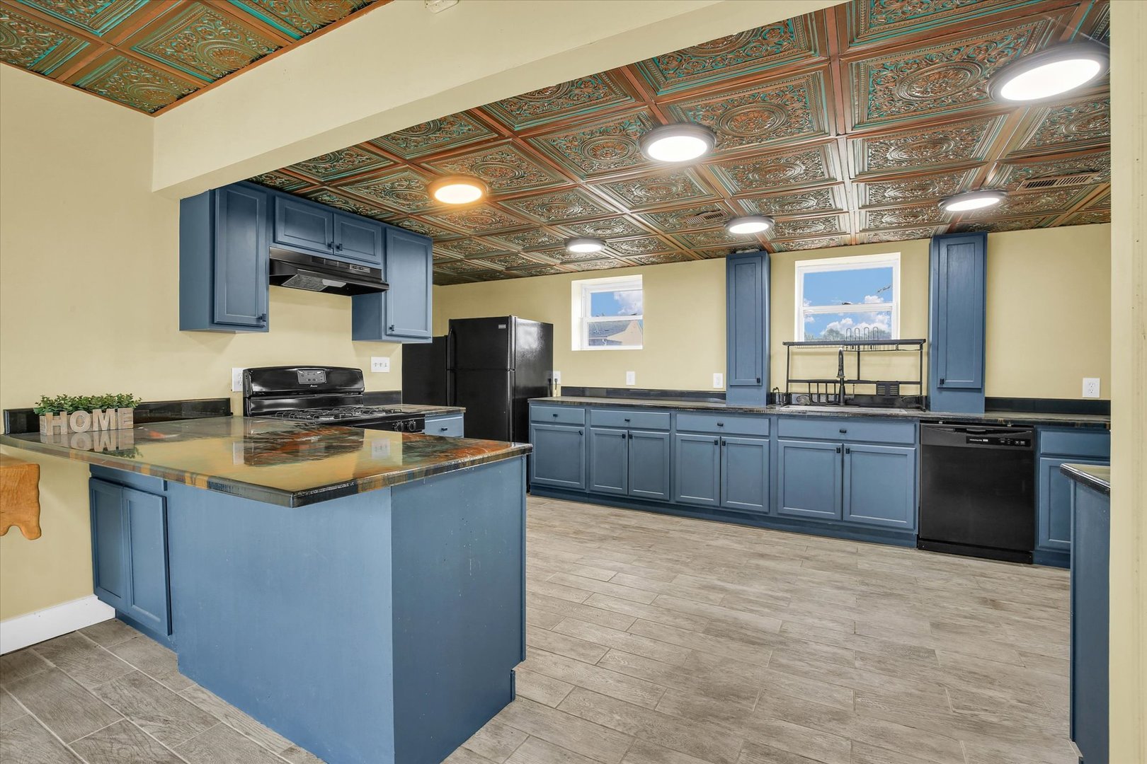 508 East Champaign Avenue Rantoul, IL 61866 - Photo 11 of 48 a kitchen with stainless steel appliances granite countertop wooden cabinets a sink and a counter