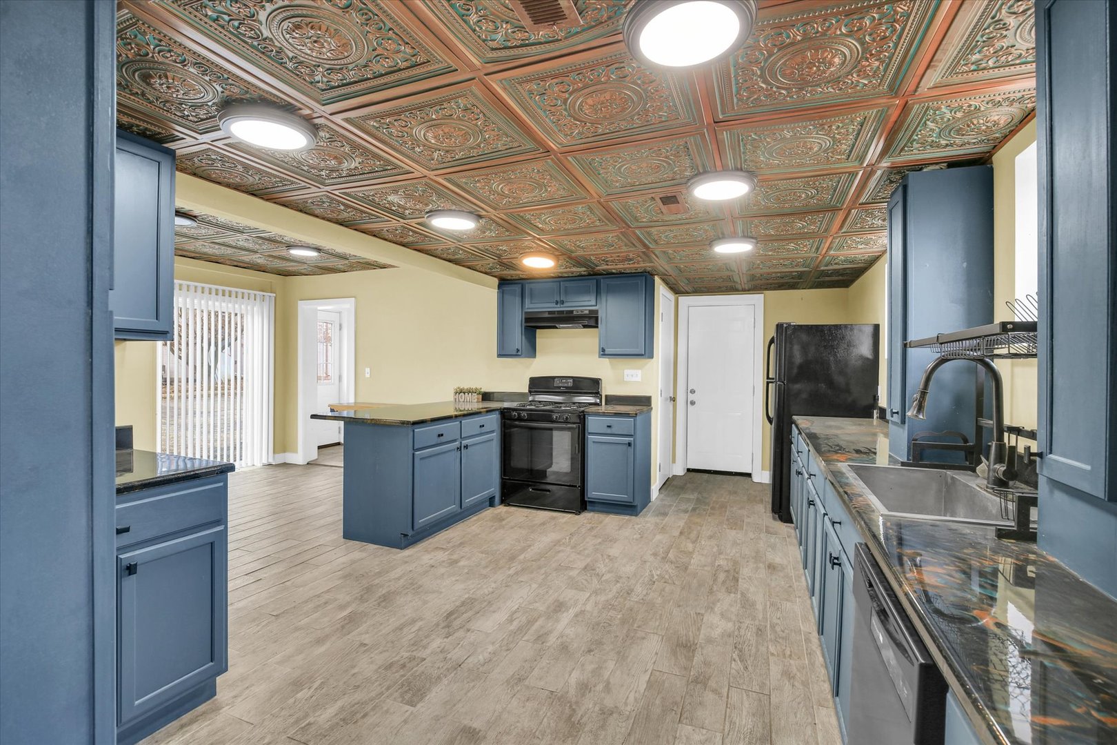 508 East Champaign Avenue Rantoul, IL 61866 - Photo 14 of 48 a large kitchen with stainless steel appliances granite countertop a large stove a sink dishwasher and cabinets with wooden floor