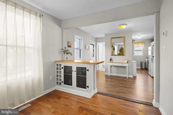 a living room with fireplace and wooden floor