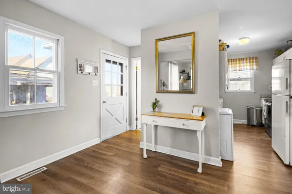 a workspace with wooden floor and windows