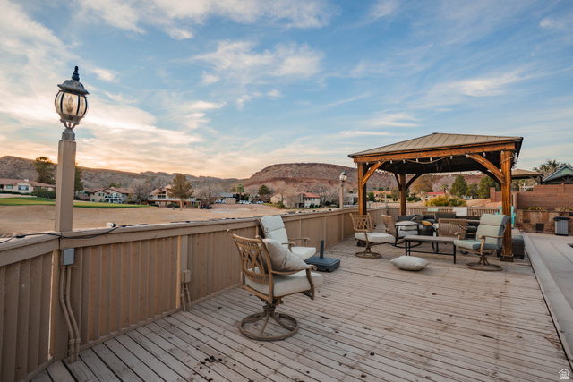 980 Cactus Circle St. George, UT 84790 - Photo 60 of 77 Wooden deck featuring outdoor furniture, a residential view, a mountain view, and a gazebo